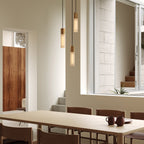 Pendentif triple en basalte et laiton