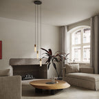 Pendentif triple en basalte et laiton